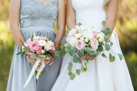 the bride holds the bouquet of flowers in her hand, the wedding floral bouquetの写真素材