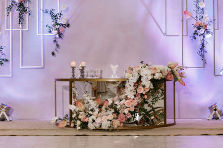 Newlyweds table with festive floral decor on wedding with natural flowersの写真素材