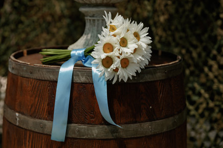 Ukrainian brides wedding bouquet of white daisies tied with a blue ribbonの写真素材