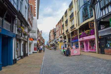 Chester, UK, 22.06.2021: the main shopping street of the city with view to historic buildings. At the moment these are shops, cafes and pubs.のeditorial素材