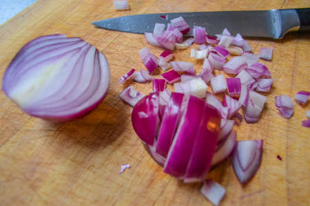 Sliced red onion and black knifeの写真素材
