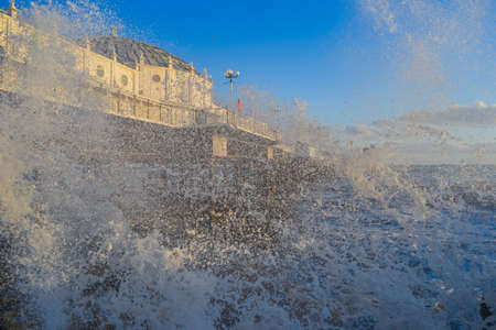 UK, Brighton, 01.10.2021: Photo of waves and splashes in the storm, the famous Brighton pier in the backgroundのeditorial素材