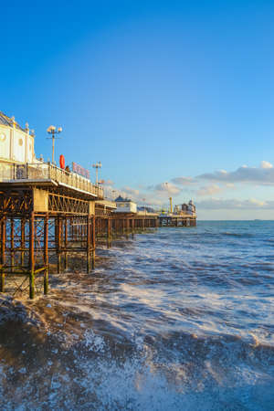 UK, Brighton, 01.10.2021: Photo of waves and splashes in the storm, the famous Brighton pier in the backgroundのeditorial素材