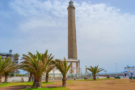 Maspalomas, Las Palmas, Spain, 17.09.2021: Landmark 1890s lighthouse, a popular place to watch the sunset, with a beach, shops and bars nearby.のeditorial素材