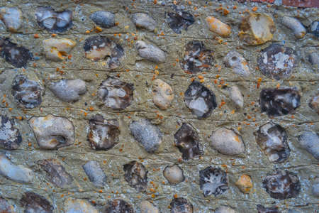 A closeup shot of a stone wall with small pebblesの写真素材