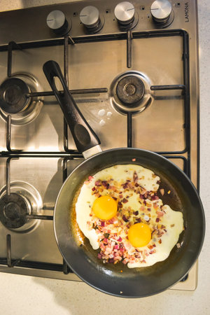 Fried eggs with onions in a pan - cook at home