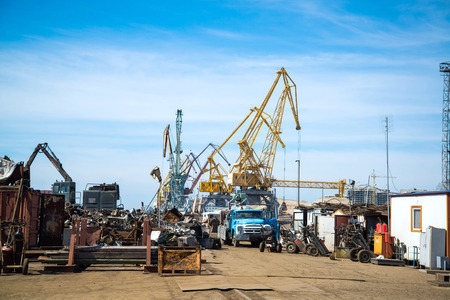 Cranes and old junk in portの写真素材
