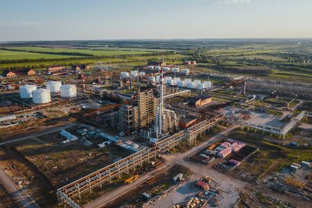 Aerial view oil and gas refinery construction site. Pipes and large tanks and scaffoldの写真素材