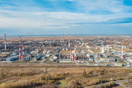 Oil and gas refinery large facility. Pipes and large tanks for oil conversionの写真素材