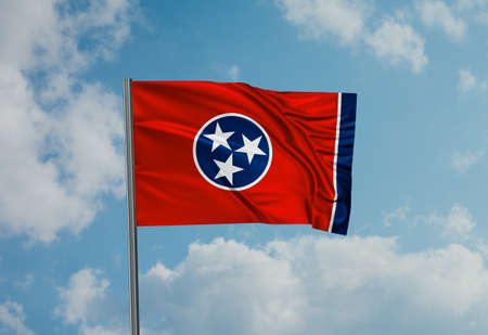 Oklahoma US state flag waving in the wind on sky with cloudsの写真素材