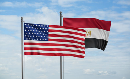 Egypt flag and USA flag waving together on blue sky, two country cooperation conceptの写真素材