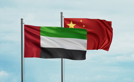 China flag and United Arab Emirates, UAE flag waving together on blue sky, two country cooperation conceptの写真素材