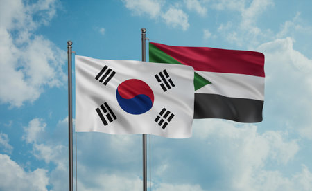 Sudan and South Korea flag waving together in the wind on blue sky, two country cooperation concept