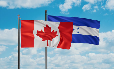Honduras and Canada flag waving together in the wind on blue sky, two country cooperation conceptの写真素材