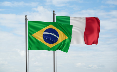 Italy and Brazil flag waving together in the wind on blue sky, two country cooperation conceptの写真素材