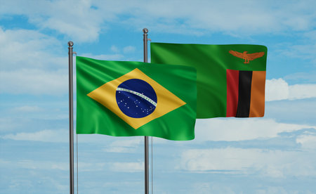 Zambia and Brazil flag waving together in the wind on blue sky, two country cooperation conceptの写真素材