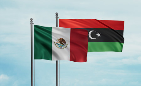Libya and Mexico flag waving together in the wind on blue sky, two country cooperation conceptの写真素材