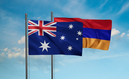 Armenia and Australia flag waving together in the wind on blue sky, two country cooperation conceptの写真素材
