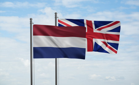 United Kingdom and Netherlands flag waving together in the wind on blue sky, two country cooperation conceptの写真素材