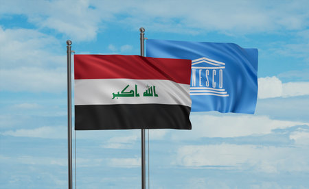 UNESCO and Iraq flag waving together in the wind on blue skyのeditorial素材