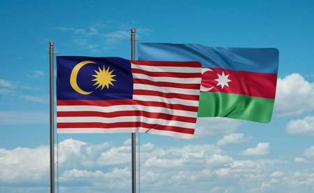 Azerbaijan and Malaysia flag waving together in the wind on blue sky, two country cooperation...