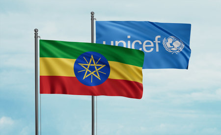 UNICEF and Ethiopia flag waving together in the wind on blue skyのeditorial素材