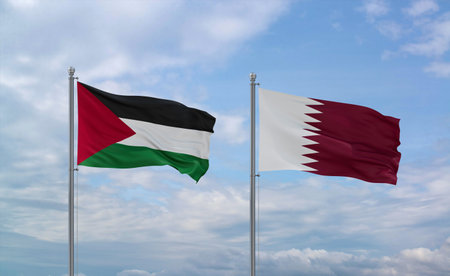 Qatar and Palestine and Gaza Strip flags waving together in the wind on blue cloudy sky, two country...