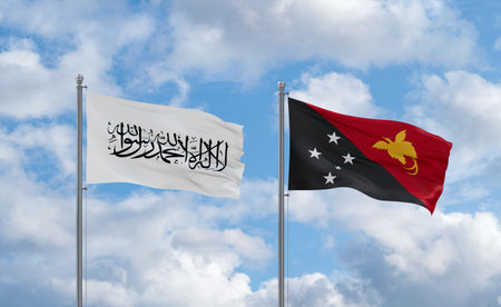Papua New Guinea and Afghanistan flags waving together on blue cloudy sky, two country relationship conceptの写真素材