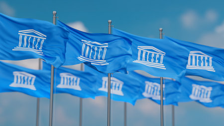 UNESCO many flags in row waving together on blue cloudy sky, cooperation conceptのeditorial素材