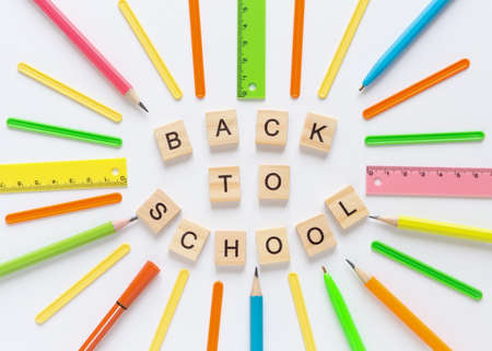 School background with wooden letters text Back to school. Flat lay with multicolored supplies. Back to school concept.の写真素材