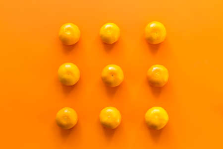 Mandarin, tangerine citrus fruit on orange background. Top view.