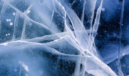 Ice surface of Baikal lake in Siberia with cracks.の写真素材