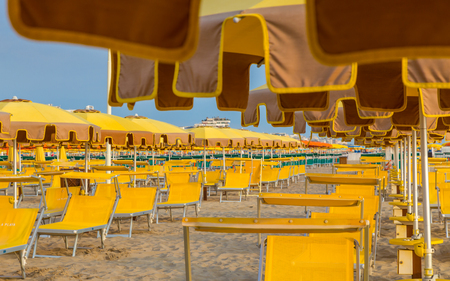 Rows of chaise longues with umbrellas on a  beachの写真素材