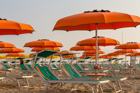 Rows of chaise longues with umbrellas on a  beachの写真素材