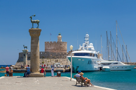 19 JUNE 2017. People in Mandraki port of Rhodes town, Greeceのeditorial素材