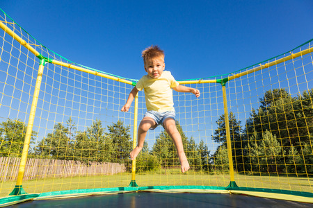 Little boy jumping on a trampolineの写真素材