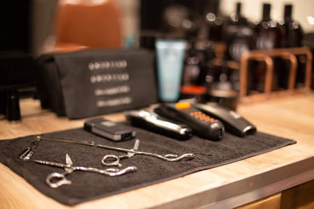 Professional barber tools in barbershop on blurred backgroundの写真素材