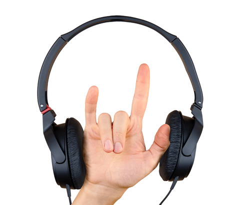 A hand with horns gesture and headphones isolated on white background. Hard rock and heavy metal conceptの写真素材