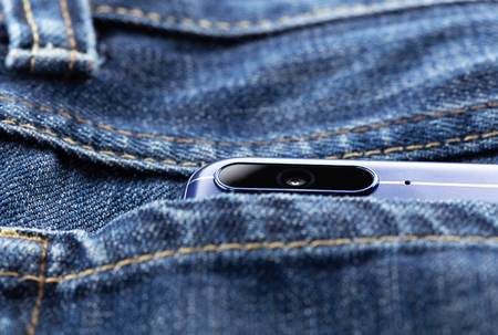 Smartphone with dual camera in back pocket of jeans. Mobile photography concept