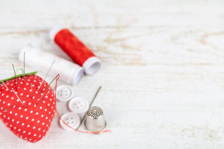 Flat lay of tools for tailoring and needlework  on white wooden backgroundの写真素材