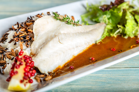 Plate of steamed dorado fillet with crispy riÑeの写真素材