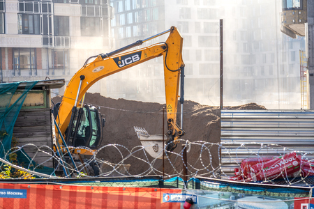 10/18/2018 Moscow, Russia: Excavator on a construction site of new residential buildingsのeditorial素材