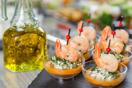 Set of appetizers. Small plates of salad with shrimpsの写真素材