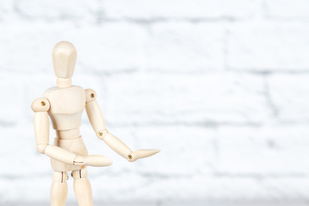 Mockup with wooden human puppet holding  palms upの写真素材