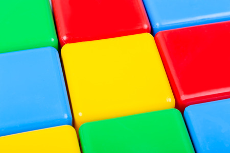 Closeup view of plastic  toy colorful cubes. Abstract background