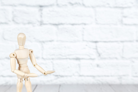 Mockup with wooden human puppet holding  palms upの写真素材