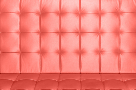 Closeup surface of luxury leather sofa of living coral color as texture or backgroundの写真素材