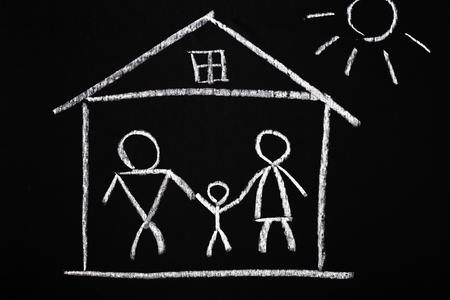Chalk drawing of a family in a house. Property or mortgage concept.の写真素材