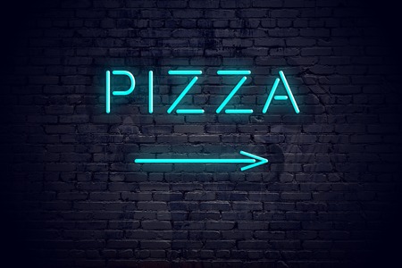 Brick wall with neon arrow and sign pizzaの写真素材