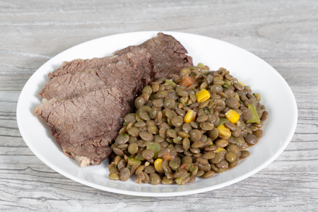Healthy food concept. Boiled beef slices with lentil and vegetables.の写真素材